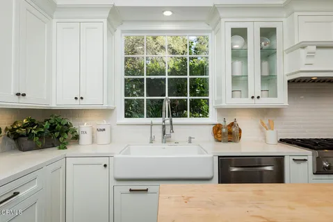 a kitchen with a stove a refrigerator and cabinets