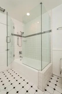 a bed sitting in a spacious bedroom next to a window and a larger closet