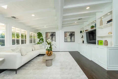 a dining room with furniture and a window