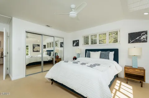 an aerial view of a house with a yard large trees