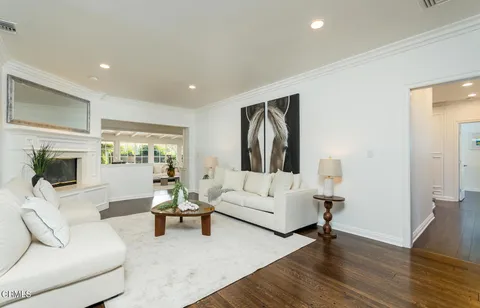 a view of a dining room with furniture wooden floor and chandelier