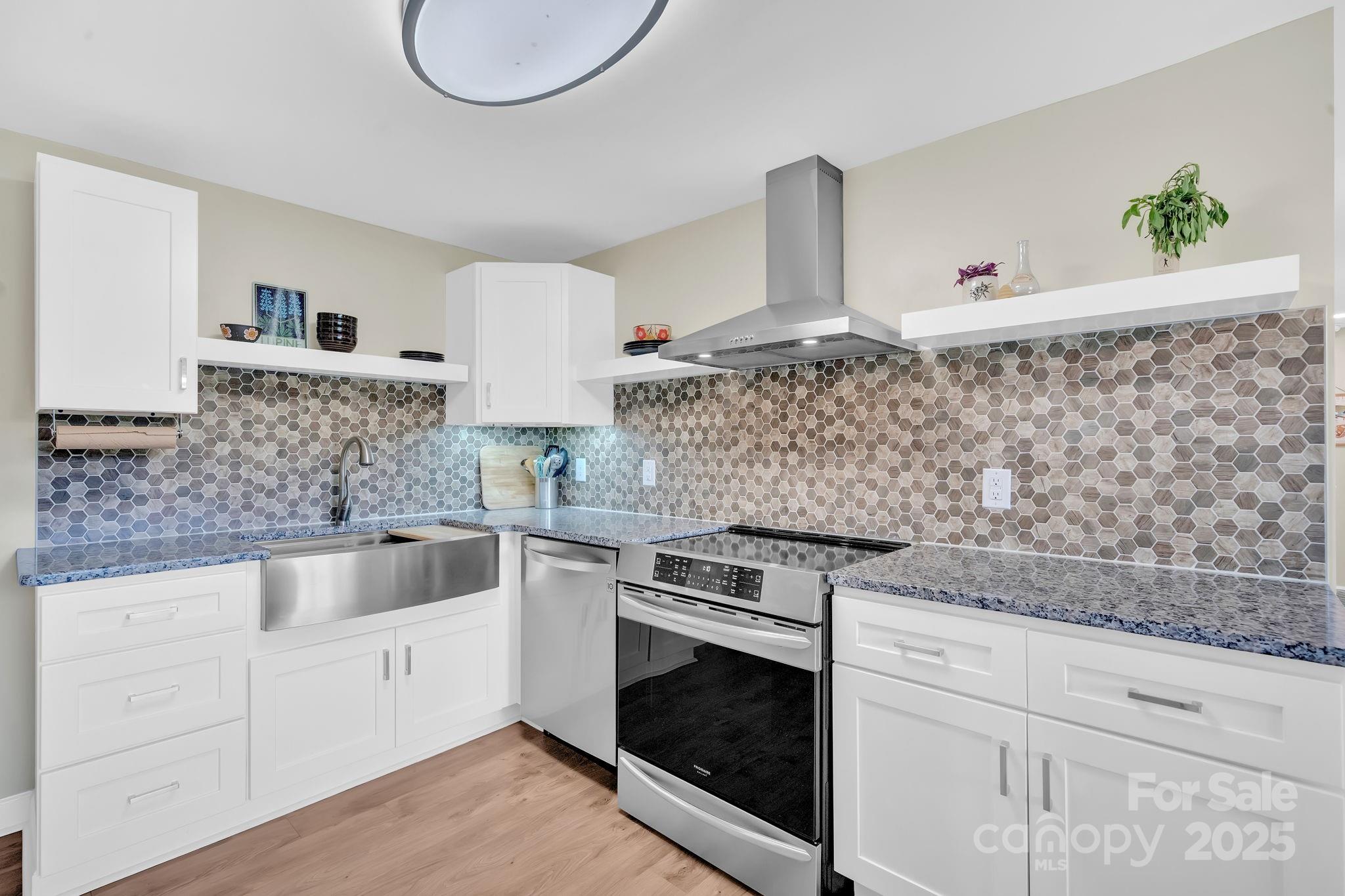 10 Moland Drive Etowah, NC 28729 - Photo 12 of 26 a kitchen with white cabinets and appliances