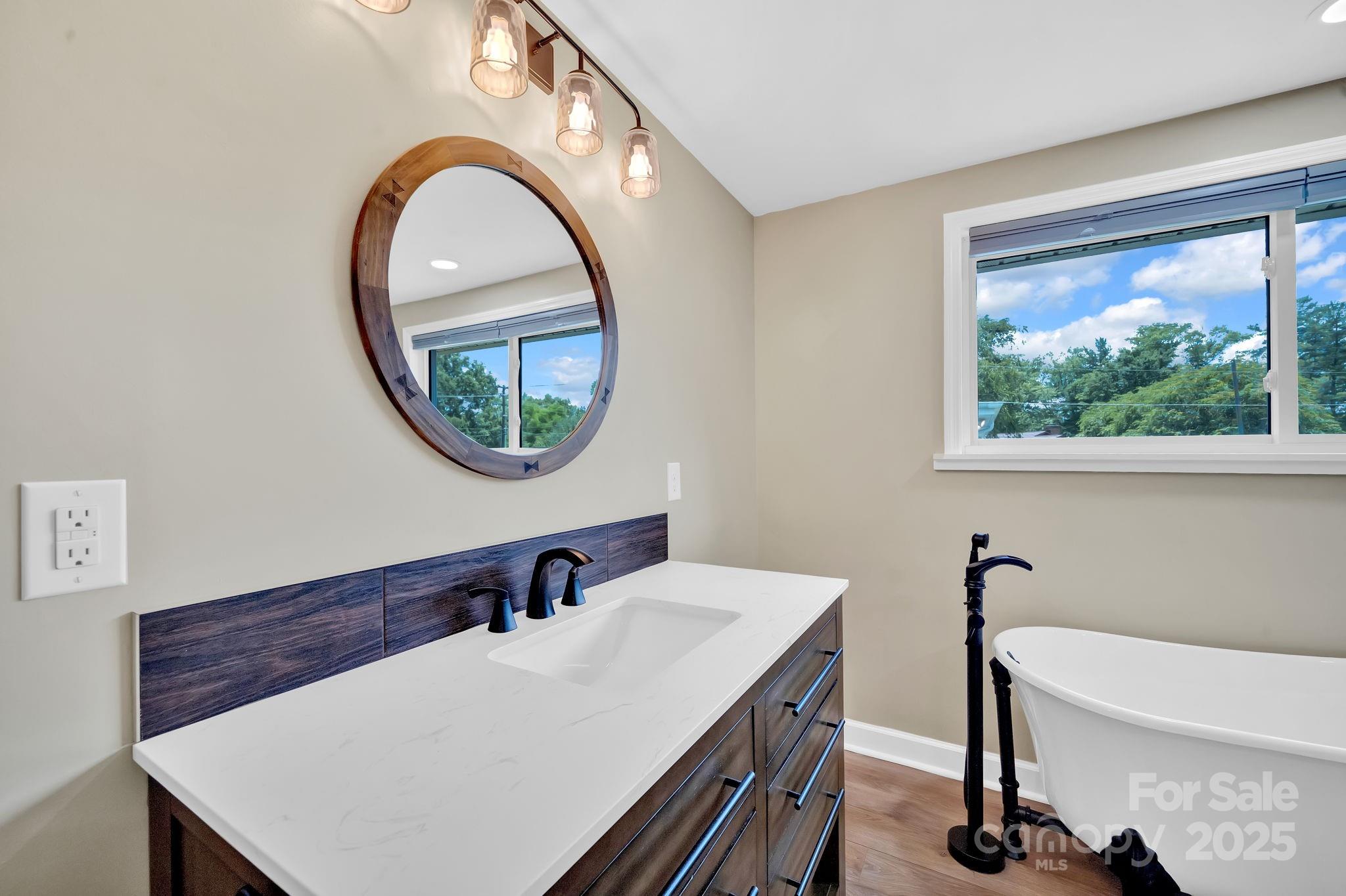 10 Moland Drive Etowah, NC 28729 - Photo 15 of 26 a bathroom with a sink a mirror and a window