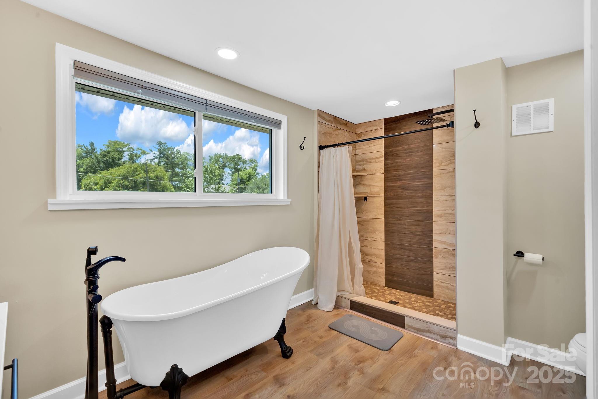 10 Moland Drive Etowah, NC 28729 - Photo 16 of 26 a bathroom with a bathtub and a shower