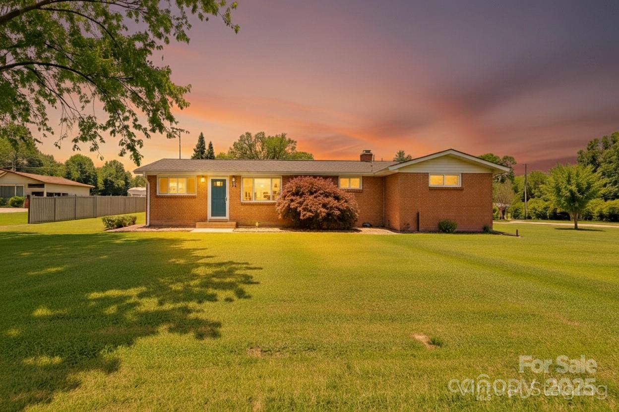 10 Moland Drive Etowah, NC 28729 - Photo 3 of 26 a front view of a house with a big yard
