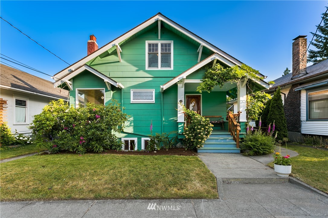 731 North 68th Street Seattle, WA 98103 - Photo 1 of 25 a front view of a house with a yard