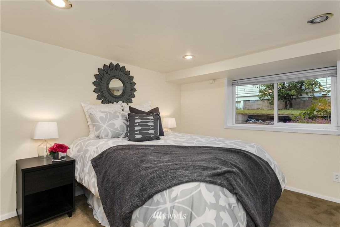 731 North 68th Street Seattle, WA 98103 - Photo 22 of 25 a bedroom with a bed and a window