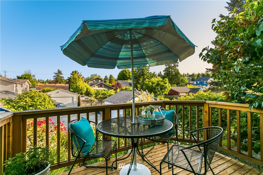 731 North 68th Street Seattle, WA 98103 - Photo 23 of 25 a view of a balcony with chairs and umbrella