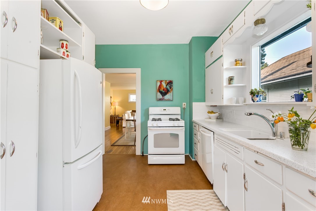 731 North 68th Street Seattle, WA 98103 - Photo 6 of 25 a kitchen with a refrigerator and a sink