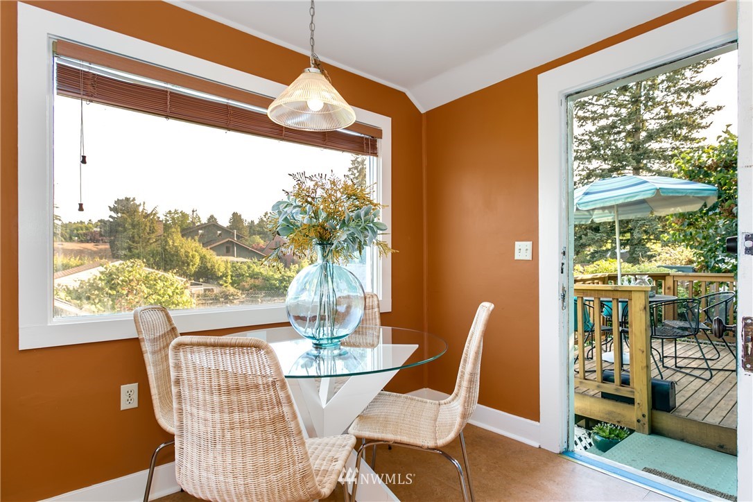 731 North 68th Street Seattle, WA 98103 - Photo 8 of 25 a view of a dining room with furniture wooden floor and a potted plant