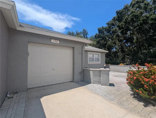 a view of a white house with a sink and dishwasher