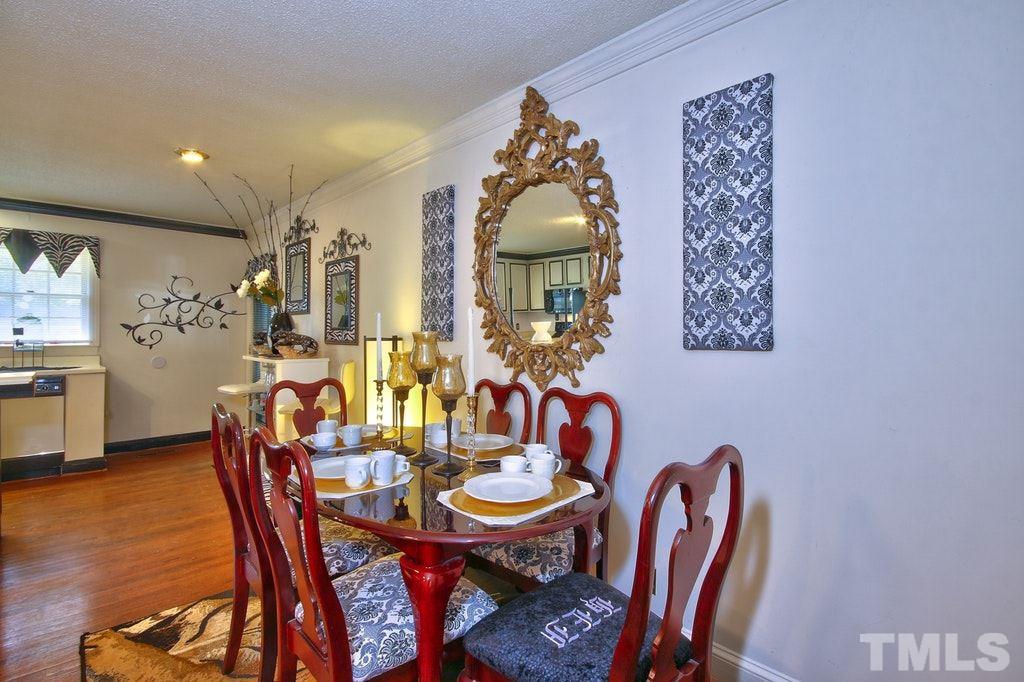2908 New Hope Church Road Raleigh, NC 27604 - Photo 9 of 24 a view of a dining room with furniture and wooden floor