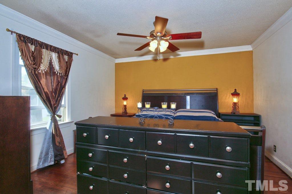 2908 New Hope Church Road Raleigh, NC 27604 - Photo 13 of 24 a bedroom with a bed and wooden floor