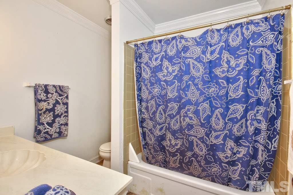 2908 New Hope Church Road Raleigh, NC 27604 - Photo 14 of 24 a bathroom with a bathtub and shower curtain