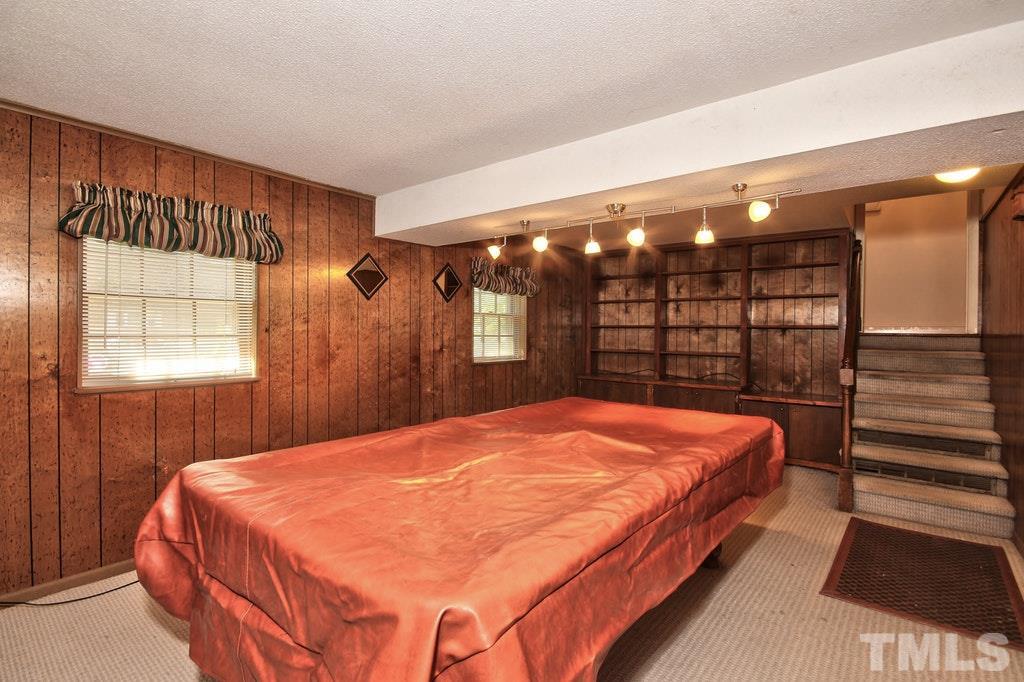 2908 New Hope Church Road Raleigh, NC 27604 - Photo 15 of 24 a bed sitting in a bedroom next to a window