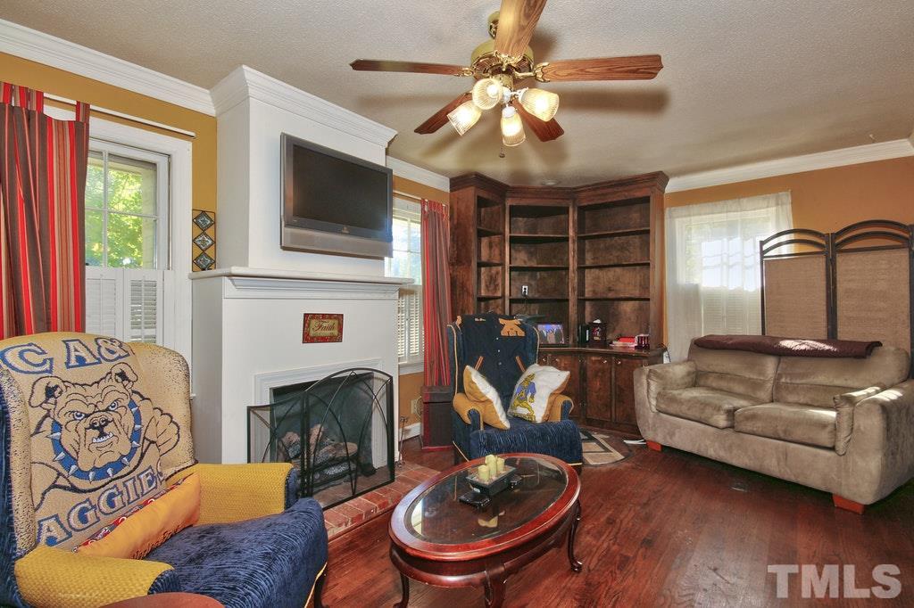 2908 New Hope Church Road Raleigh, NC 27604 - Photo 18 of 24 a living room with furniture a fireplace and a flat screen tv