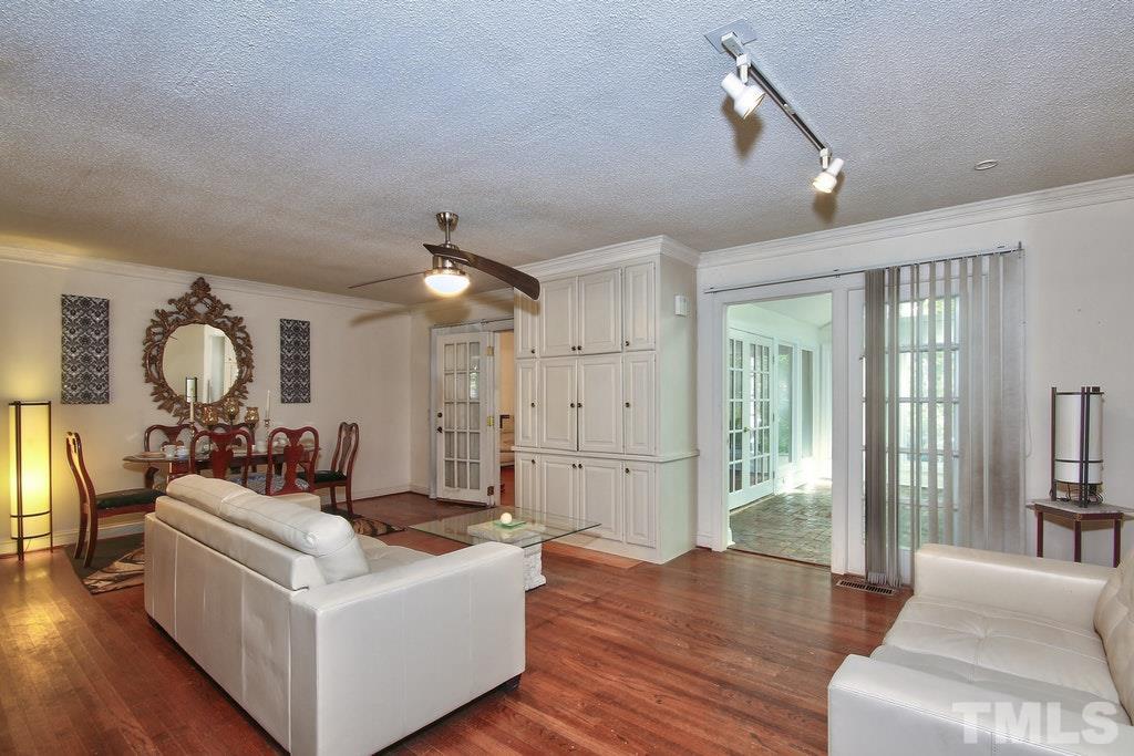 2908 New Hope Church Road Raleigh, NC 27604 - Photo 5 of 24 a living room with furniture a chandelier and wooden floor