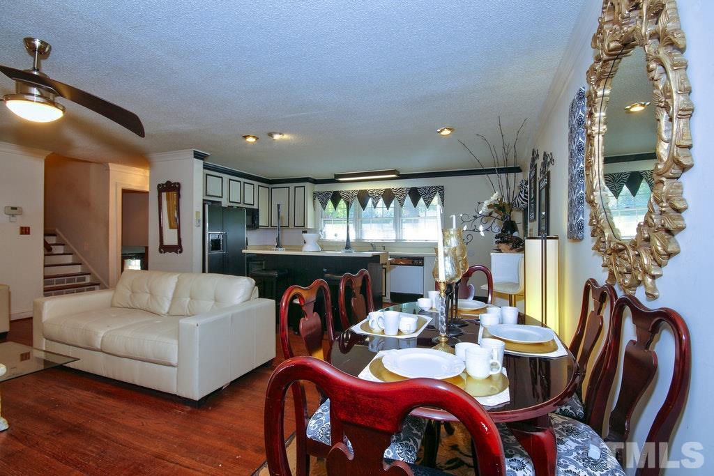 2908 New Hope Church Road Raleigh, NC 27604 - Photo 23 of 24 a living room with furniture a dining table and chairs
