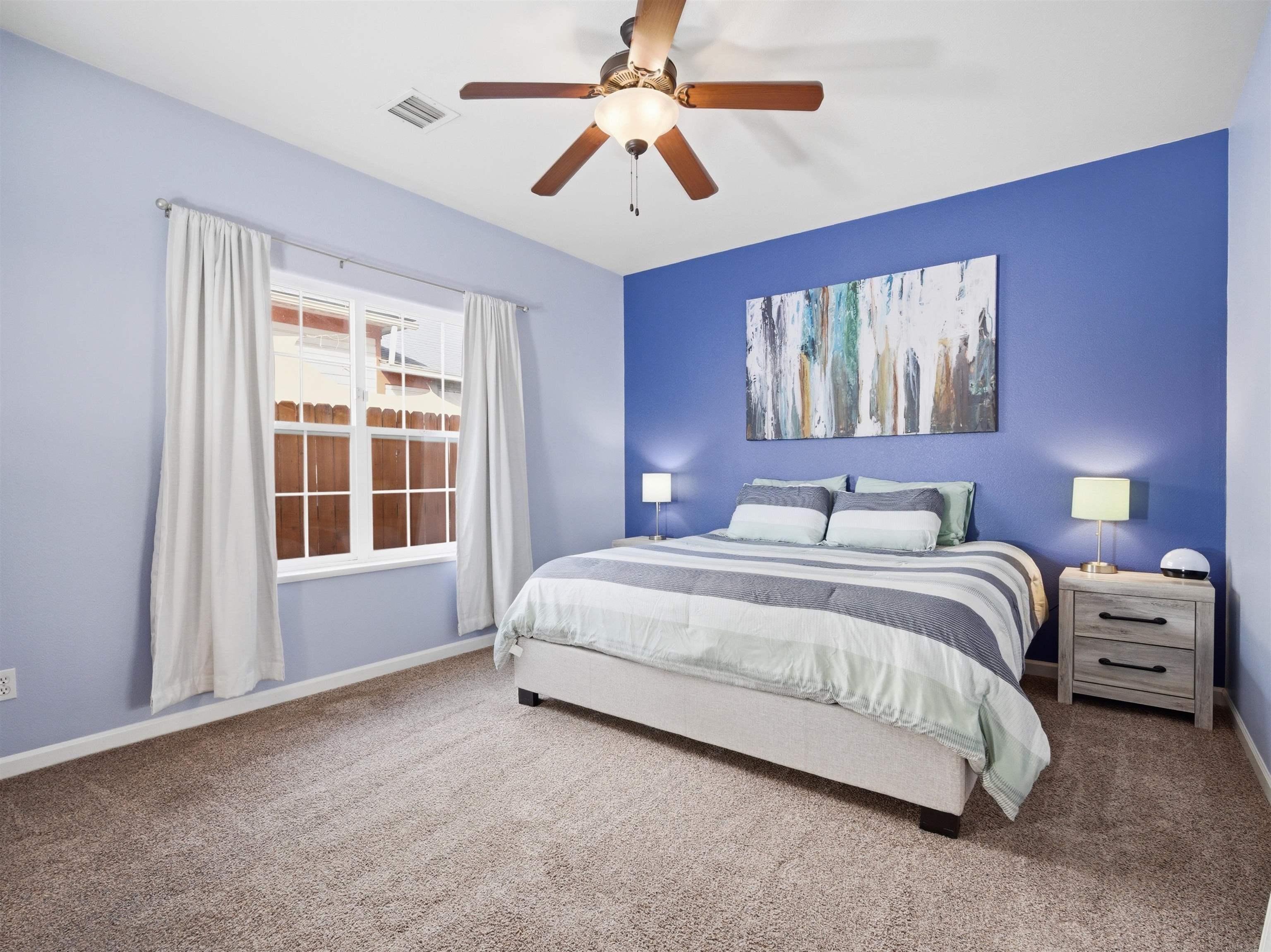 1163 Rood Avenue Grand Junction, CO 81501 - Photo 17 of 36 a spacious bedroom with a bed and a chandelier