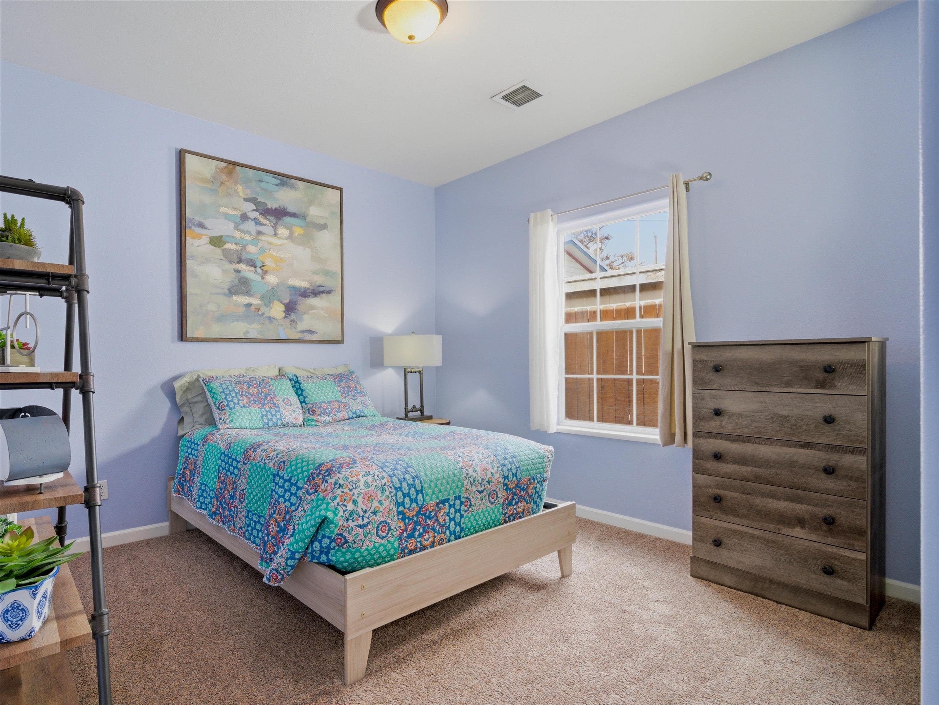 1163 Rood Avenue Grand Junction, CO 81501 - Photo 22 of 36 a bedroom with a bed and a window