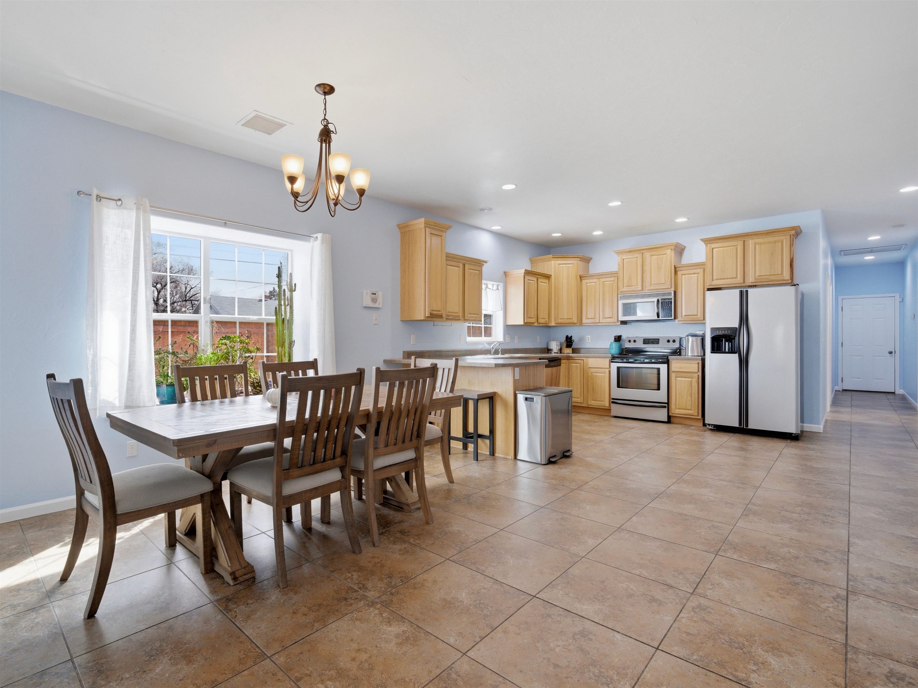 1163 Rood Avenue Grand Junction, CO 81501 - Photo 8 of 36 a dining table seating space a large window and stainless steel appliances