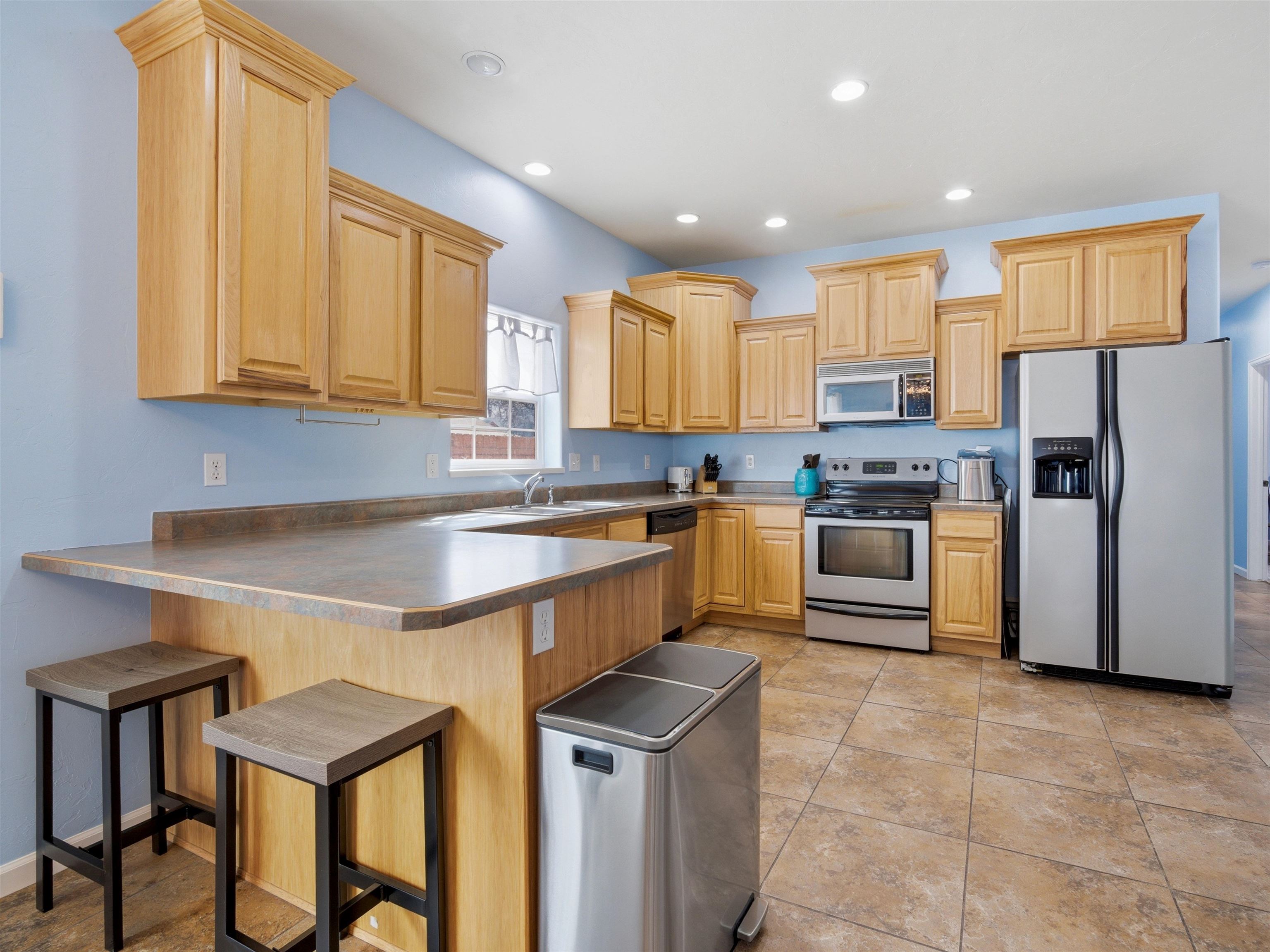 1163 Rood Avenue Grand Junction, CO 81501 - Photo 9 of 36 a kitchen with stainless steel appliances granite countertop a table chairs sink and refrigerator