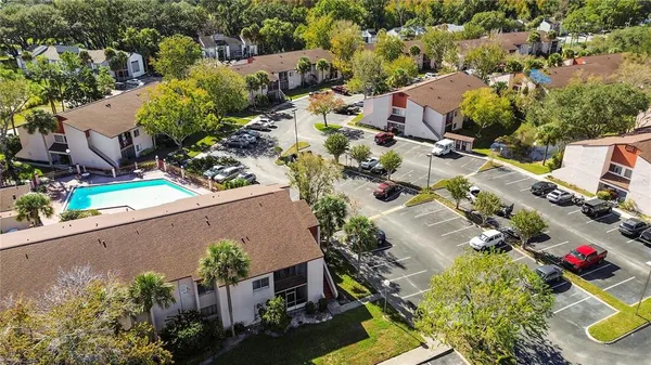 an aerial view of multiple houses with yard