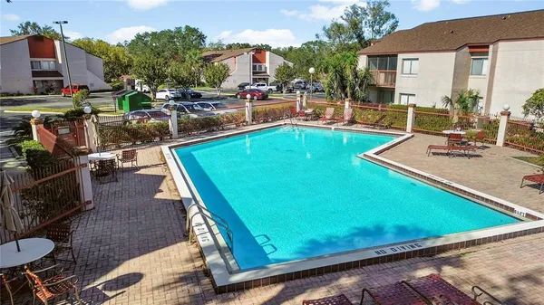 a view of a pool with chairs