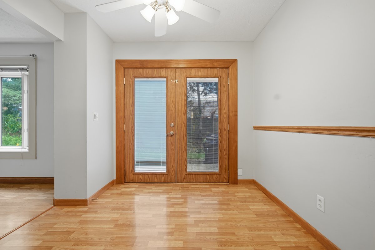 1532 Hunt Drive, Unit A Normal, IL 61761 - Photo 10 of 25 a view of an empty room with window and wooden floor