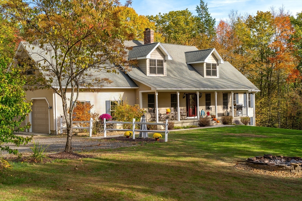 a view of a house with swimming pool and porch with furniture
