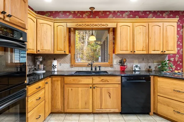 a kitchen with stainless steel appliances granite countertop a refrigerator and sink