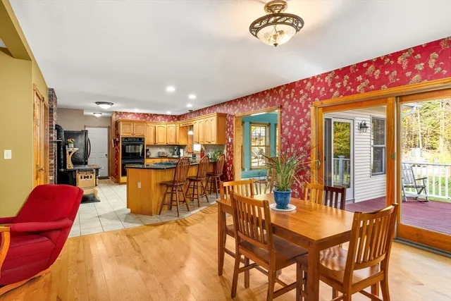 a dining room with furniture a rug and a chandelier