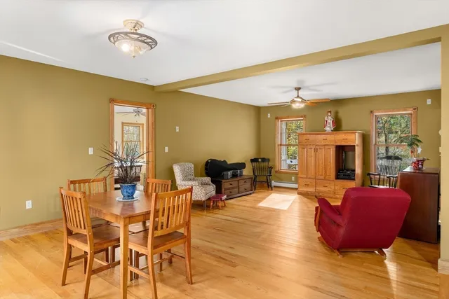 a living room with fireplace furniture and a wooden floor