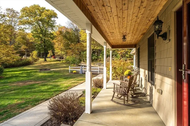 a view of a swimming pool with a patio and a yard