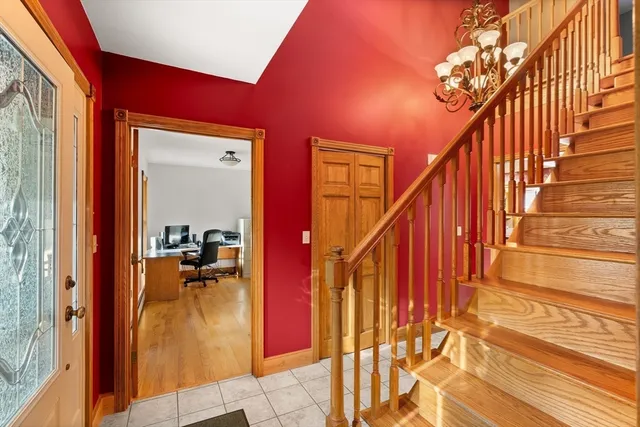 a view of entryway and hall with wooden floor