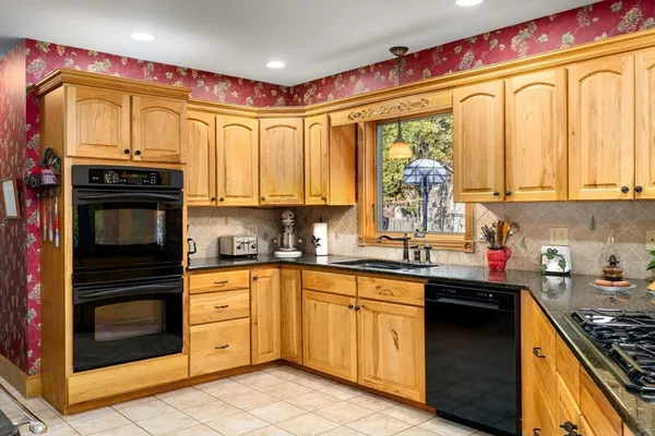 a kitchen with stainless steel appliances granite countertop a stove top oven