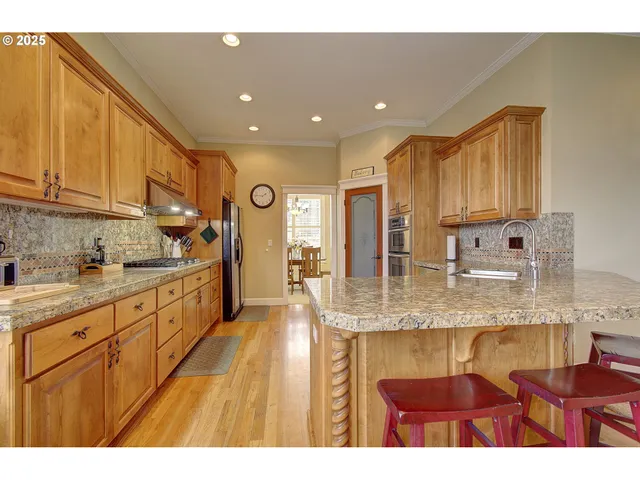a kitchen with stainless steel appliances granite countertop a granite counter tops and a sink