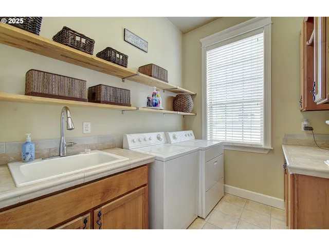 a utility room with a sink washer and dryer