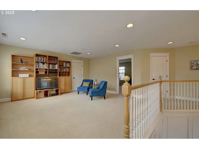 a view of a livingroom with furniture and a flat screen tv