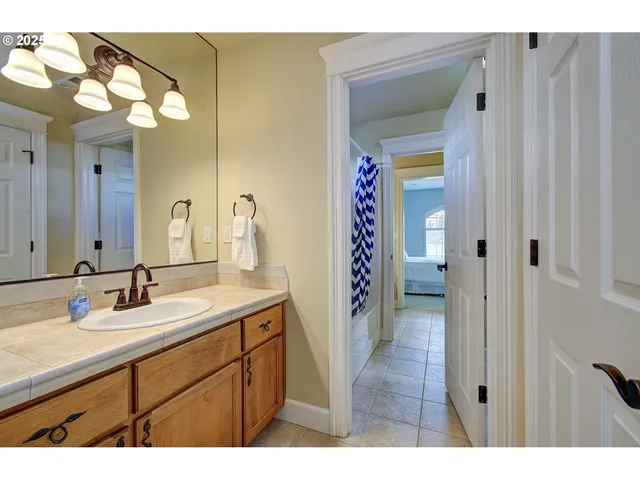 a bathroom with a sink a mirror and a shower