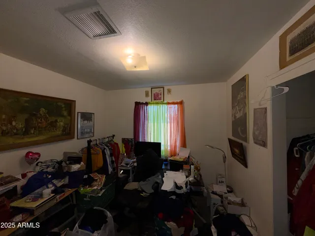 a room with furniture a flat screen tv and a window