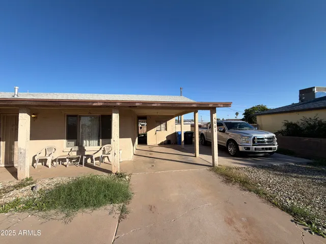 a view of a patio with table and chairs a barbeque