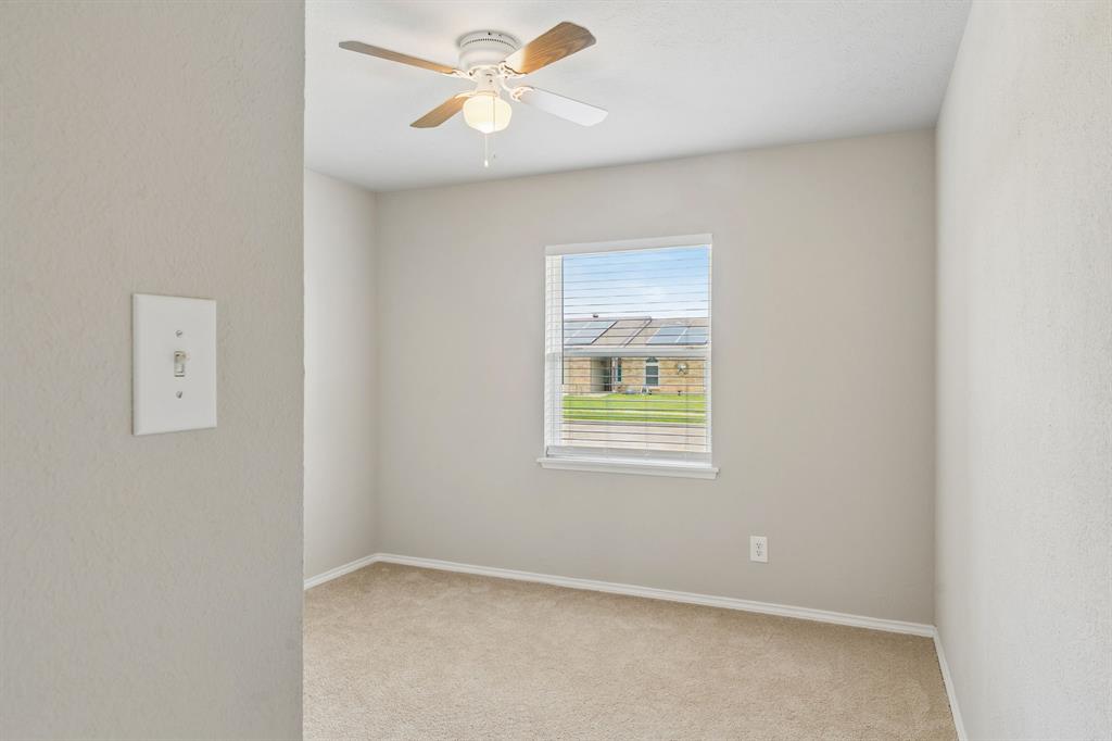 5620 Perrin Street The Colony, TX 75056 - Photo 17 of 31 an empty room with window and ceiling fan