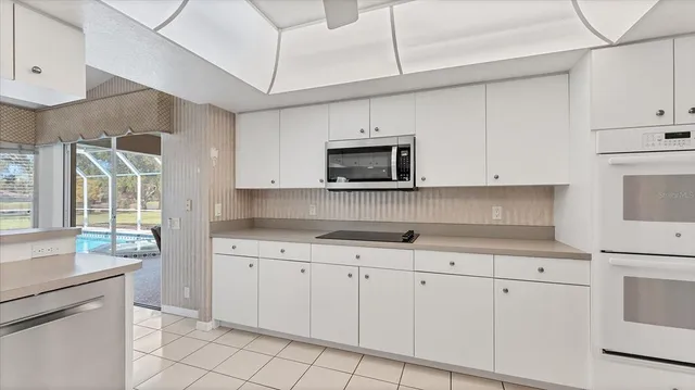a living room with furniture a fireplace and a large window