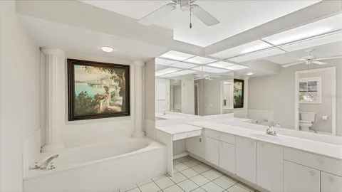 an empty room with a ceiling fan and window