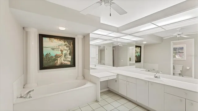 an empty room with a ceiling fan and window