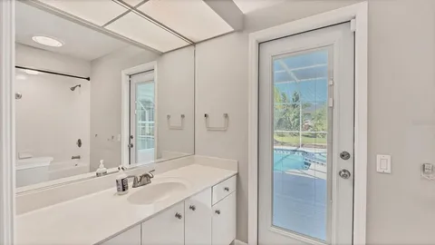 a view of a backyard with floor to ceiling windows