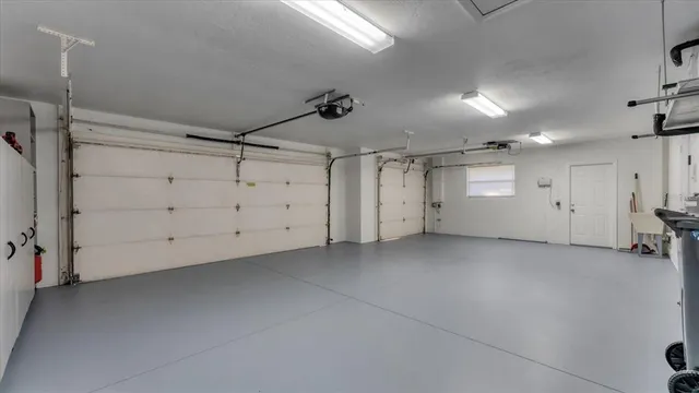 an aerial view of residential houses with outdoor space and trees