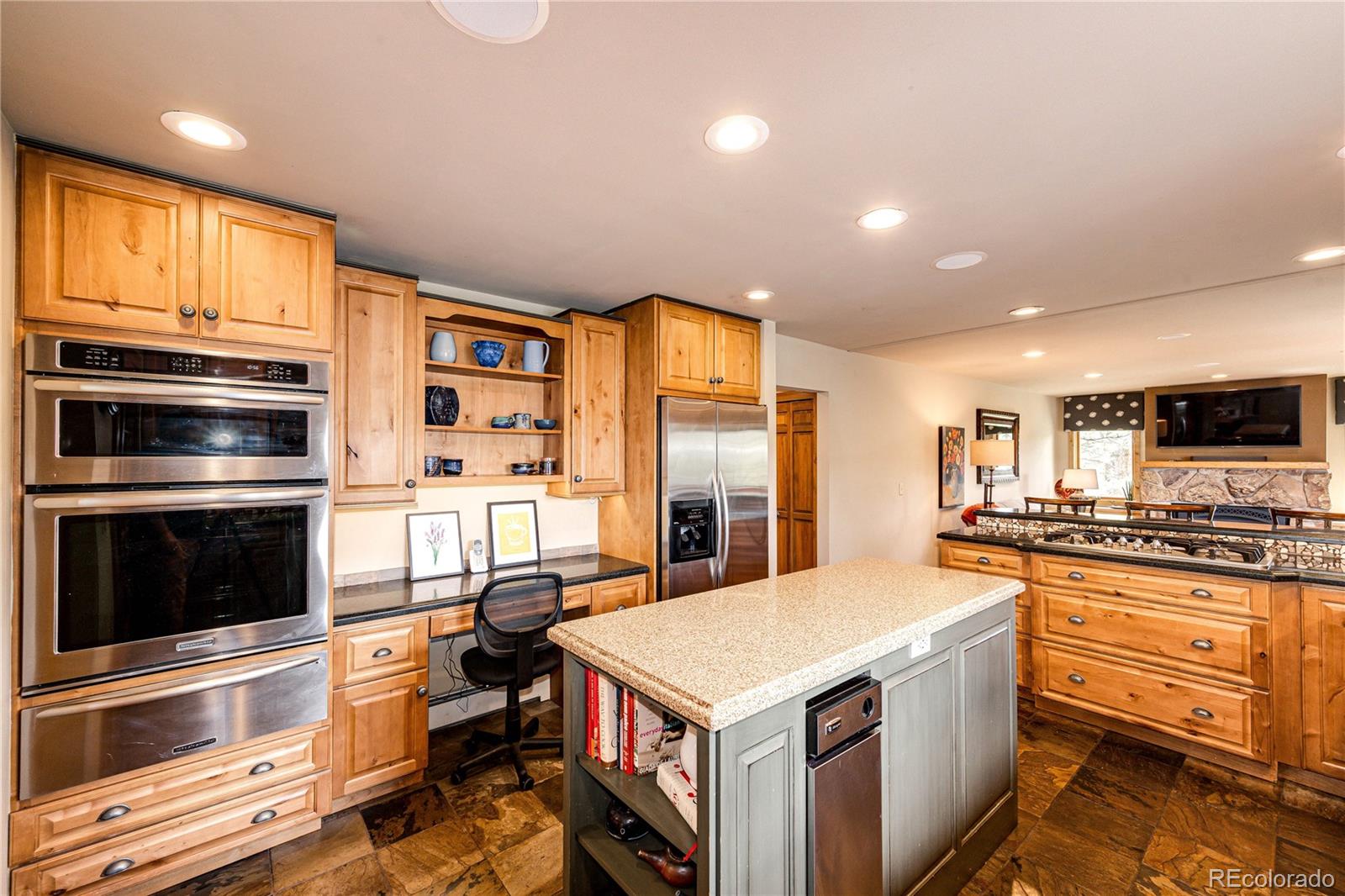 272 Greystone Road Evergreen, CO 80439 - Photo 12 of 40 a kitchen with stainless steel appliances a stove a sink and a refrigerator