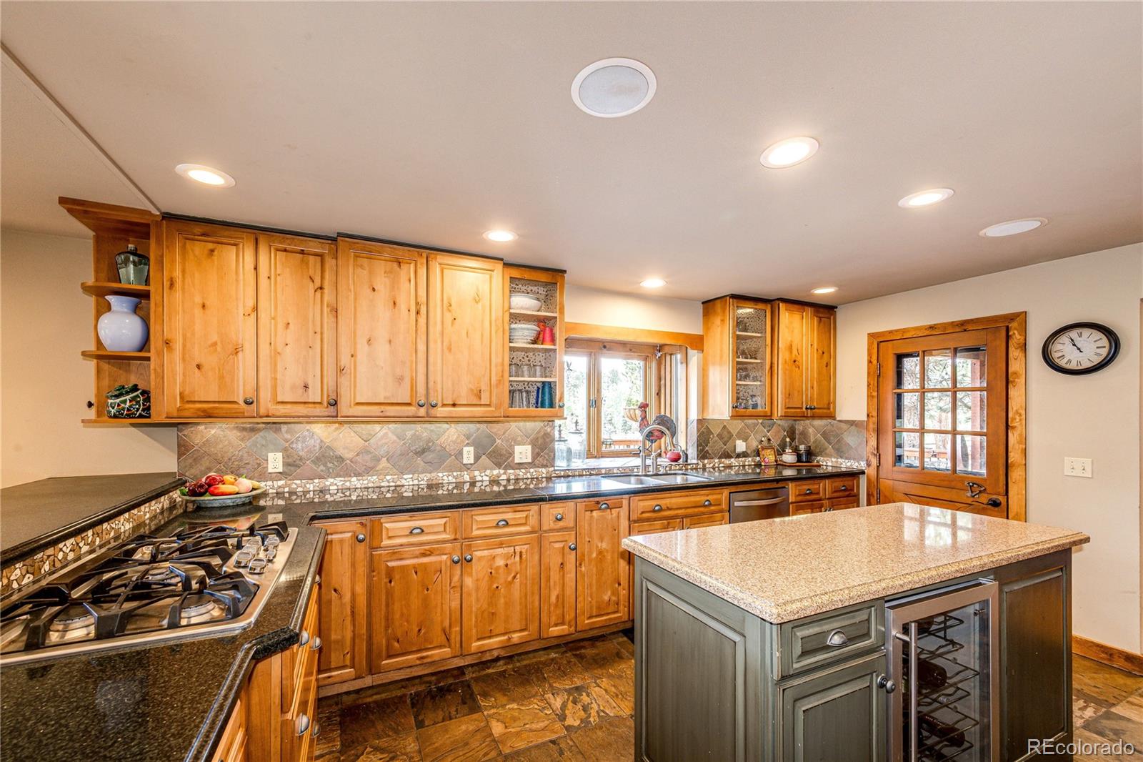272 Greystone Road Evergreen, CO 80439 - Photo 13 of 40 a kitchen with stainless steel appliances granite countertop a sink stove and cabinets